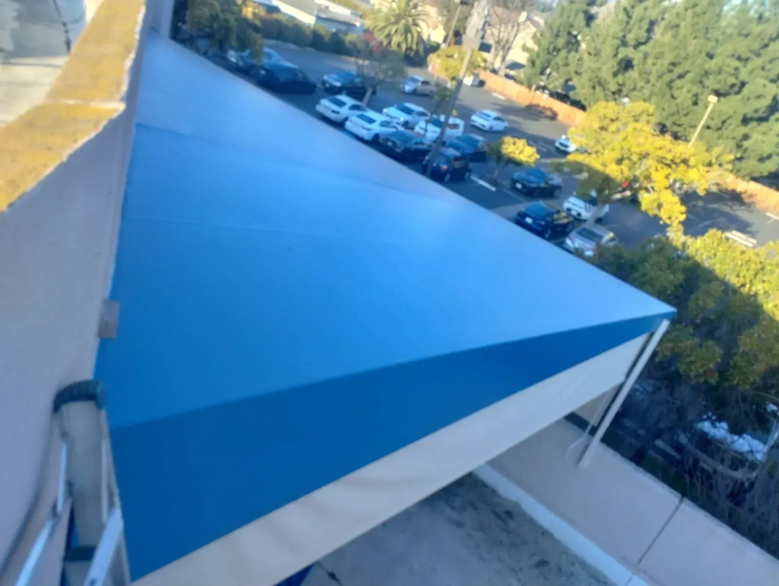 A large empty room with a ceiling that has lights hanging from it