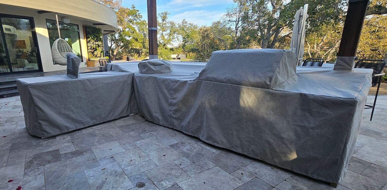 A red awning is hanging over a fence in front of a building