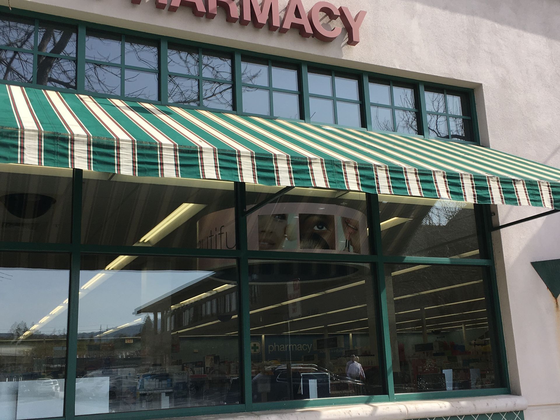 A before and after photo of a store with a blue awning.