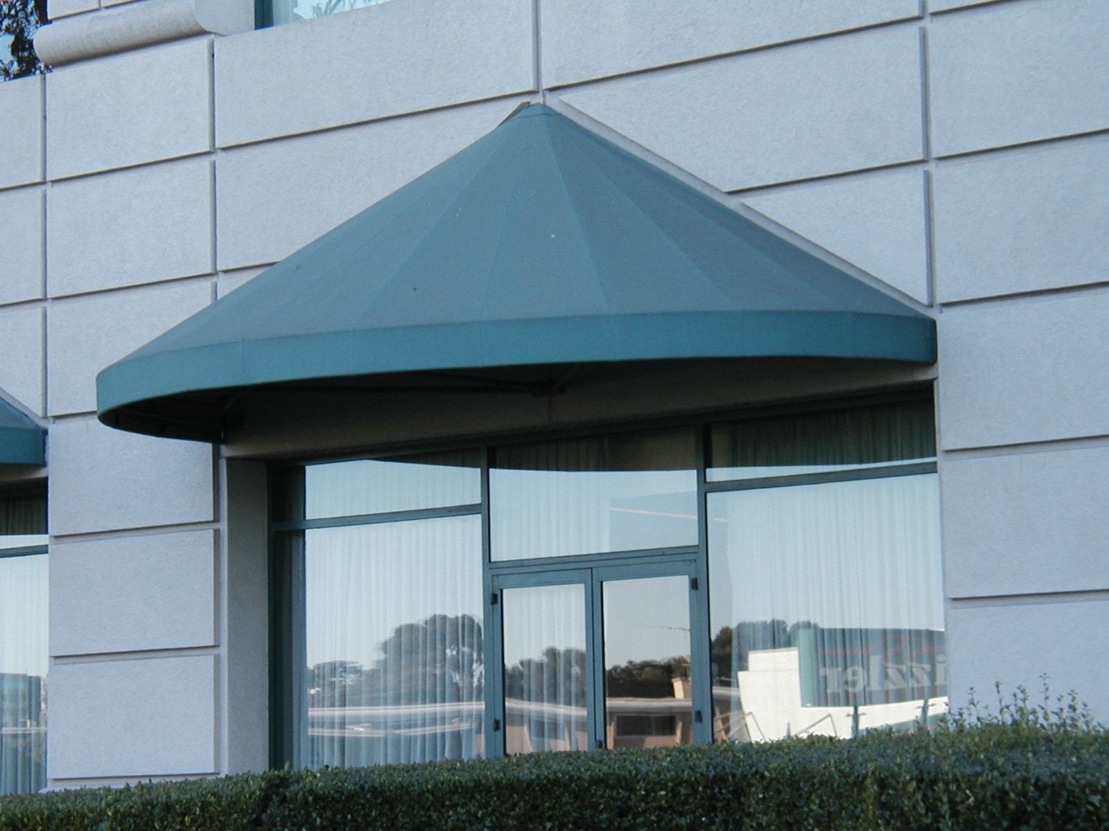 A picture of a chique jewelry store with a blue awning.