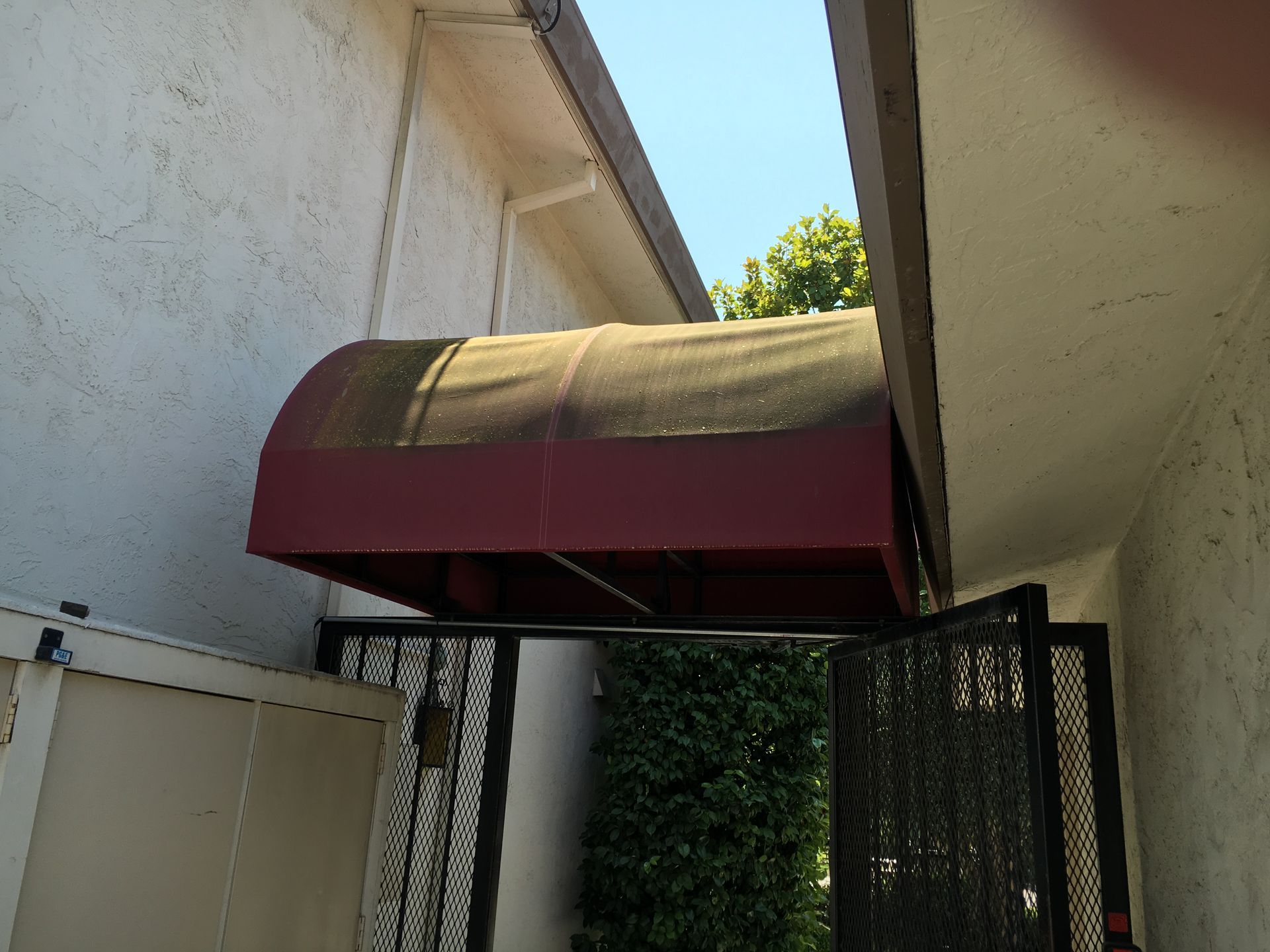 A blue awning is sitting on top of a window.