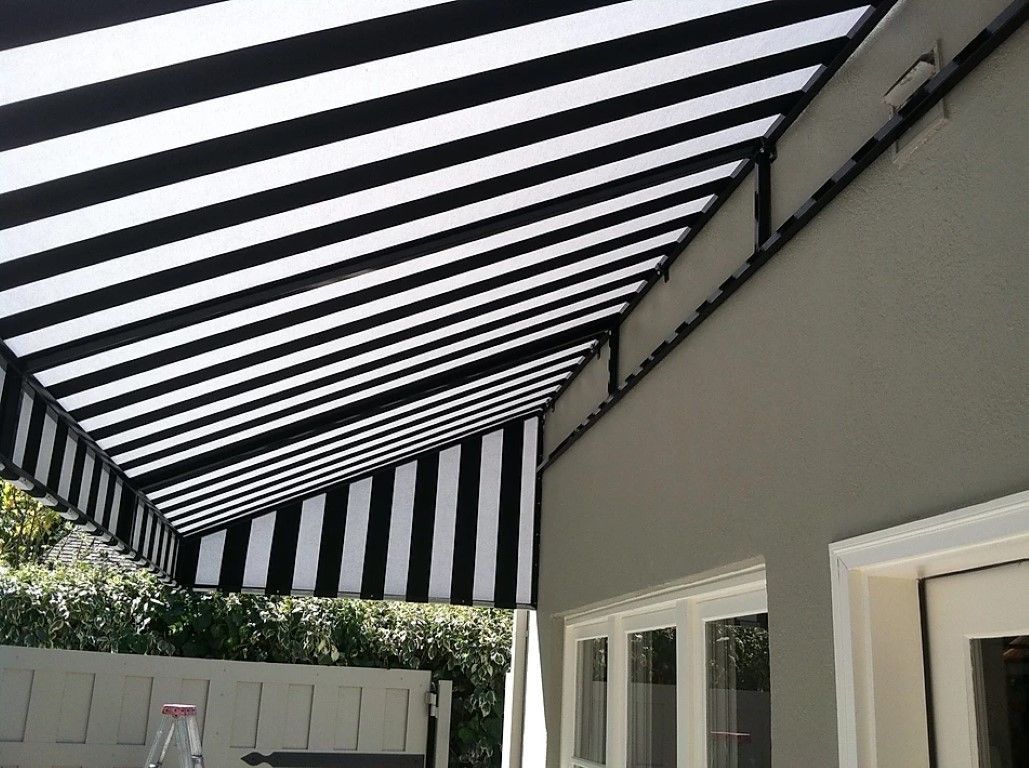 A black and white striped awning is on the side of a building