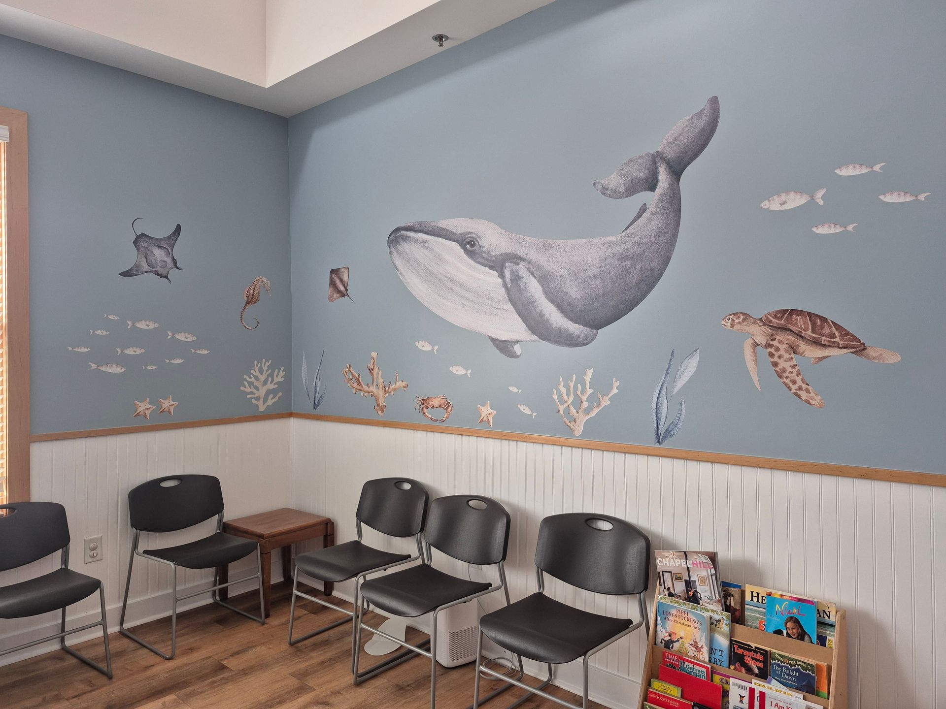 A waiting room with an under-the-sea theme