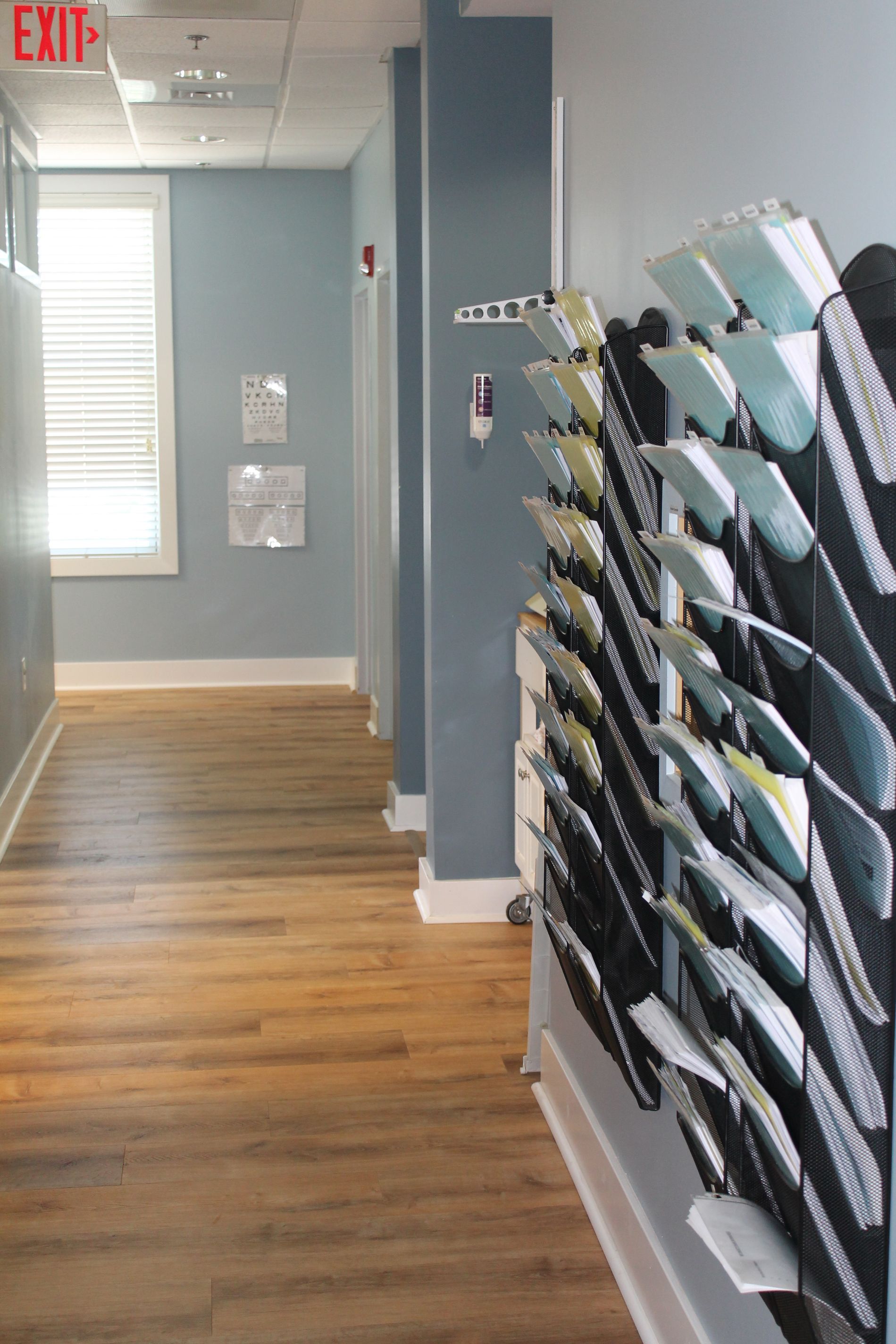 A long hallway with files on the wall and a measuring station