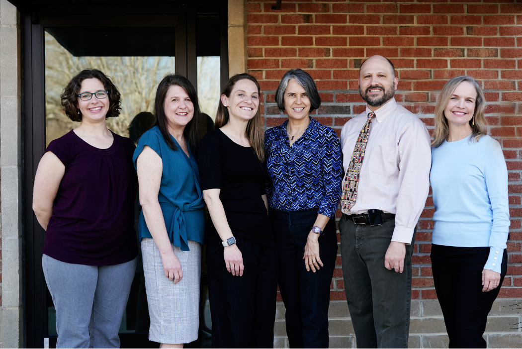 Six doctors are posing in front of Chapel Hill Children's Clinic