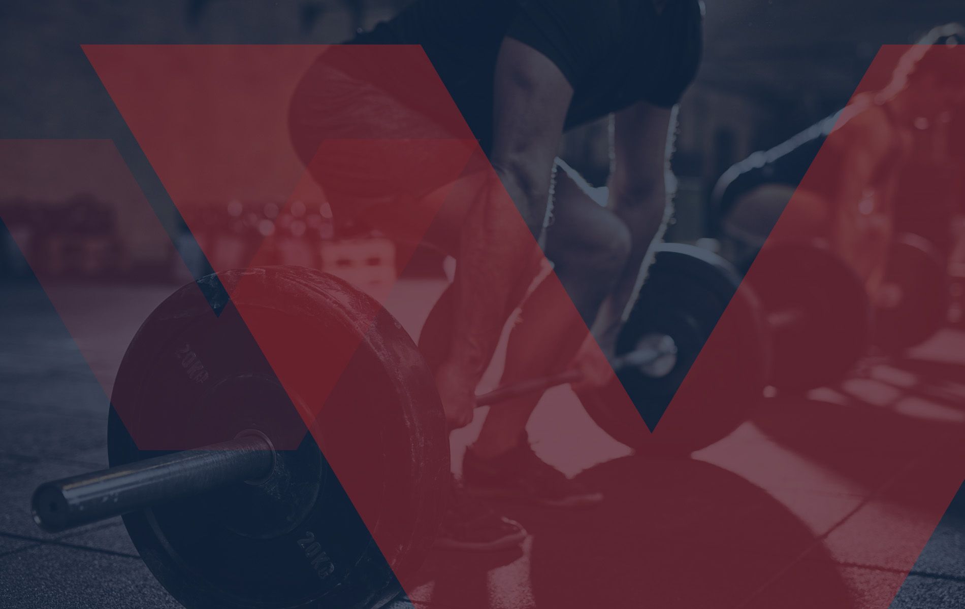 Man shirtless, exercising with a sledgehammer in a gym, chest tattoo, serious expression.