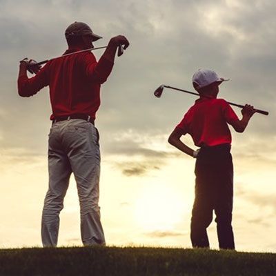 A man and a boy are playing golf together