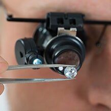 Repair jewelries - Person Looking At Diamond With Magnifying Loupe in Warren, OH