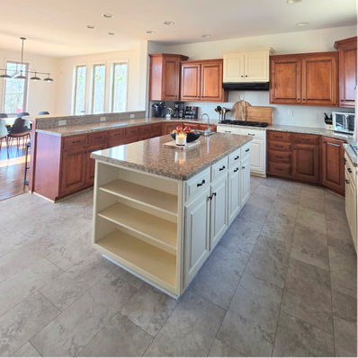 Bright kitchen with wooden cabinets and white island.