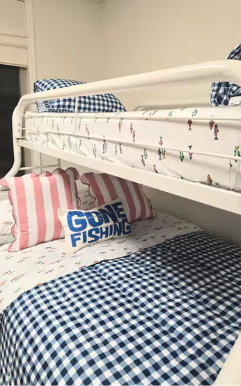 White metal bunk bed with patterned bedding and