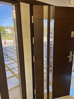 A person is cleaning a window with a squeegee.