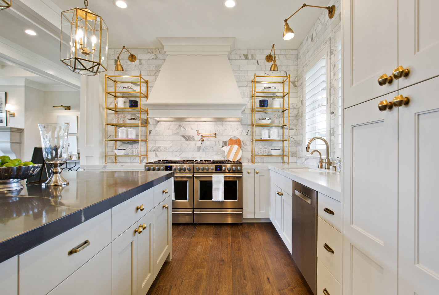 A kitchen with white cabinets and stainless steel appliances.