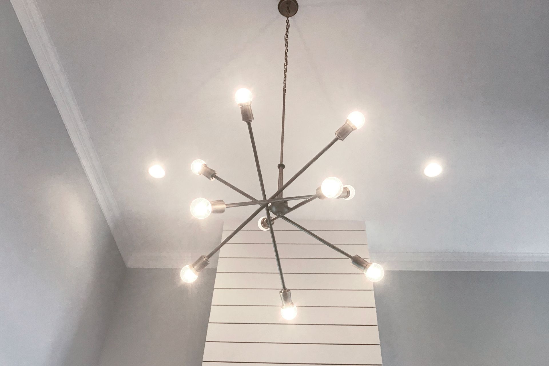 A chandelier is hanging from the ceiling in a room.