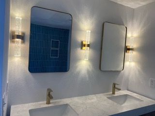 A bathroom with two sinks and two mirrors.