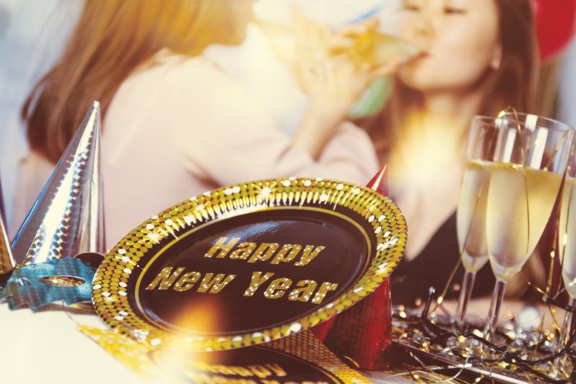 Two women are drinking champagne at a new year 's eve party.