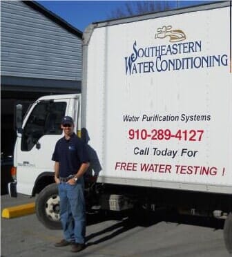 Man in front of water truck - Water filters in Magolia, NC