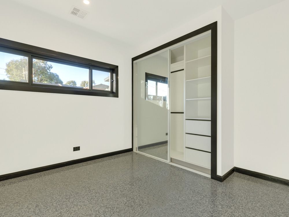 New empty room with a large mirror sliding door and built in wardrobe — Sliding Wardrobe Doors in Tamworth, NSW