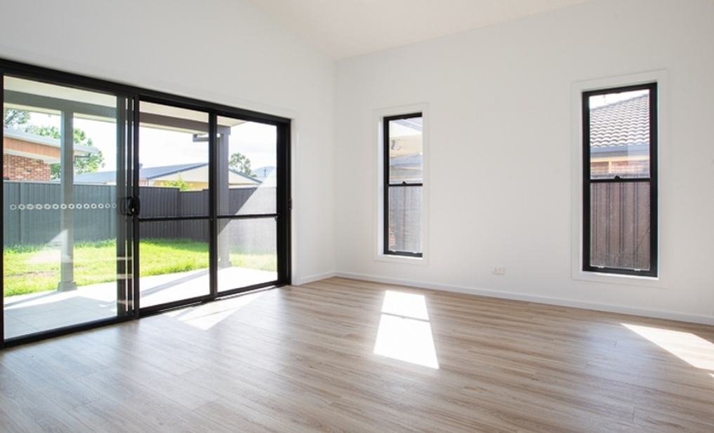 White living room with stacker doors — Stacker Doors in Tamworth, NSW