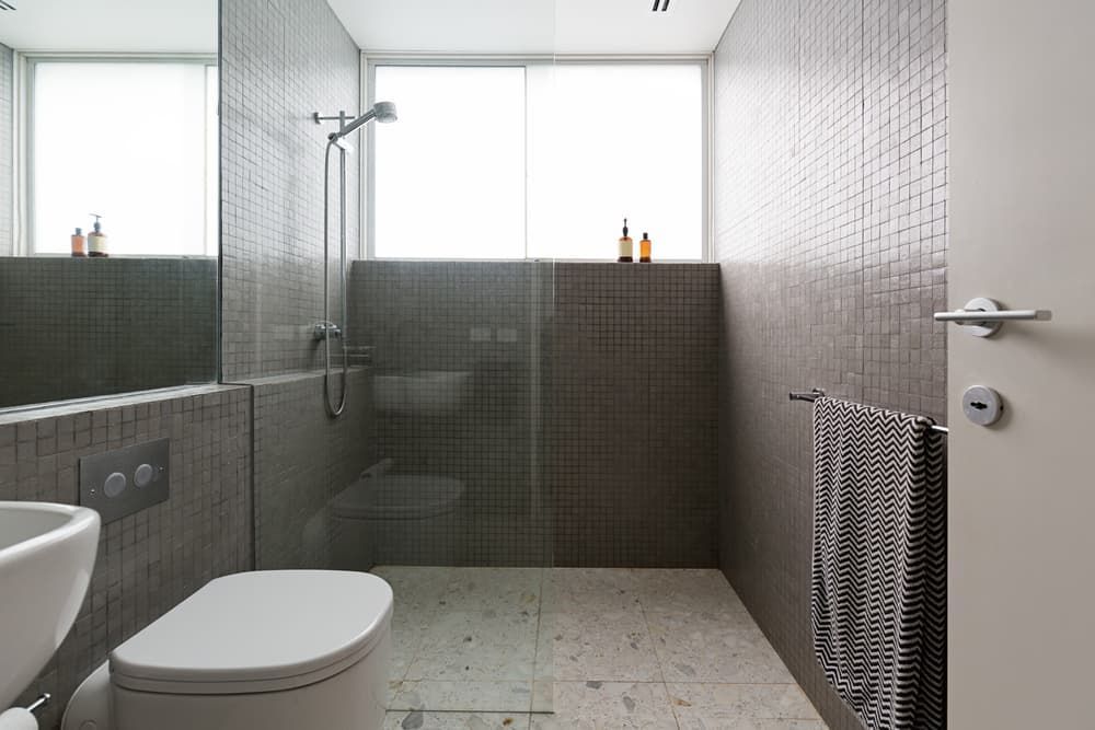 Bathroom with dark tiles — Shower Screens in Tamworth, NSW