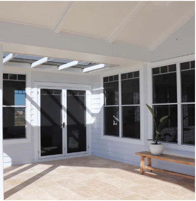 A patio with a bench and a potted plant