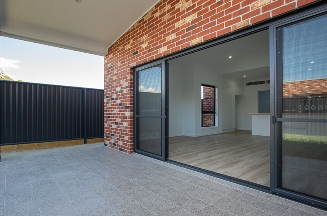 Empty living room with stacker door — Stacker Doors in Tamworth, NSW