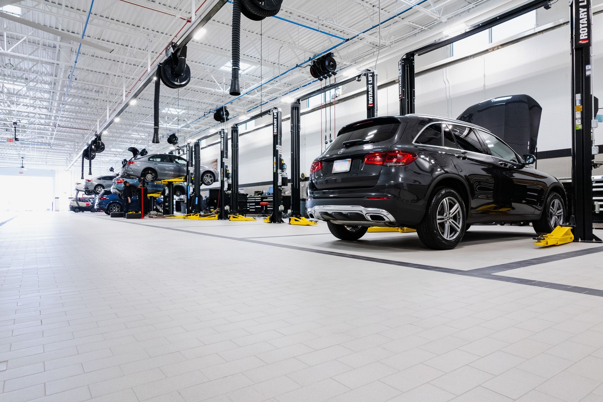An automotive workshop with Mercedes cars.