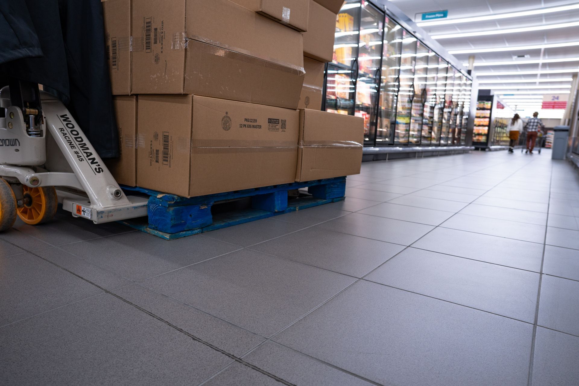 The floor of a grocery store in an isle.