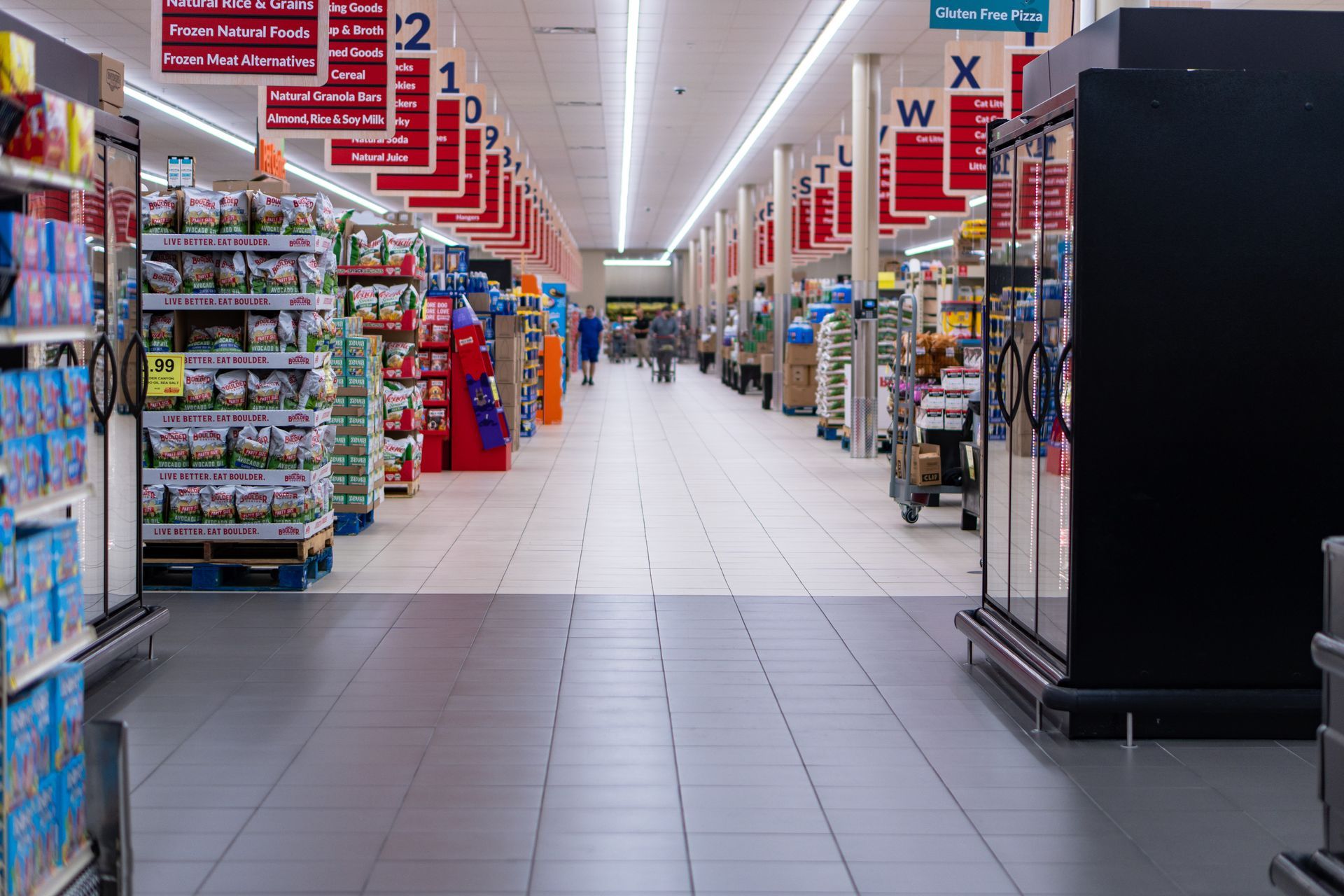 A grocery store with different isles and 2 dfferent tile colors.