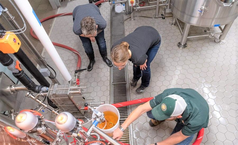 A group of people are working on a machine in a factory.