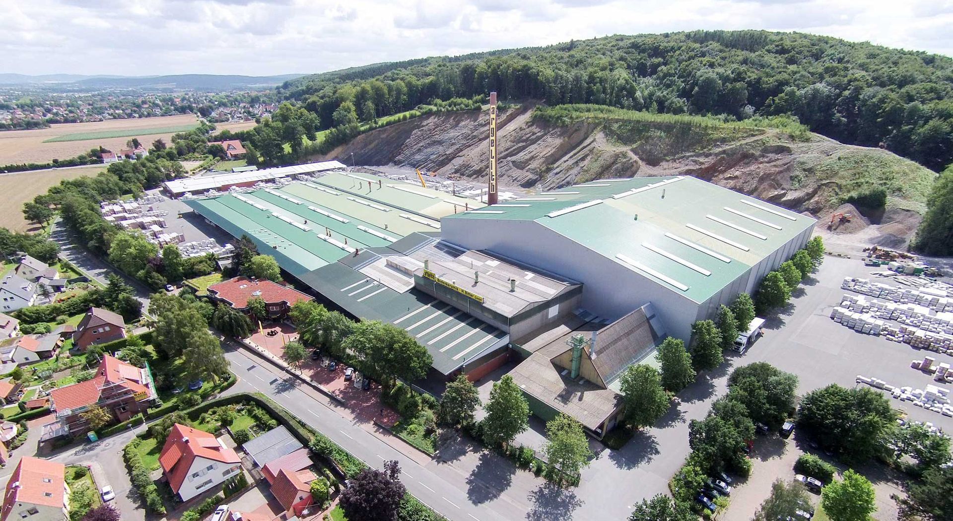 An aerial view of a large building with a green roof