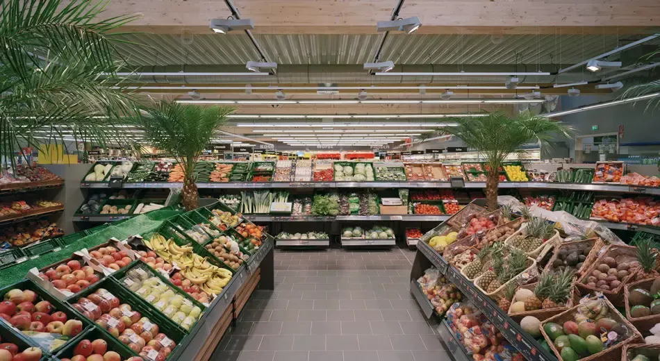 The inside of a grocery store filled with fruits and vegetables.