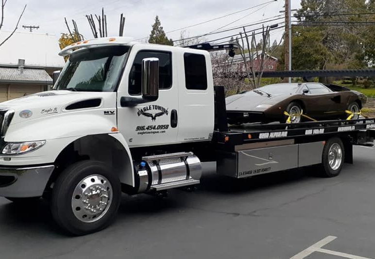 Eagle Towing Truck with White Car on the Back — Lockouts in Sacramento, CA