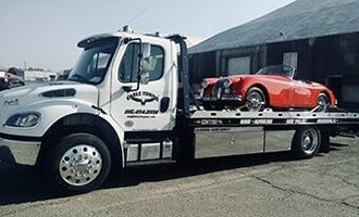 Eagle Towing Truck with White Car on the Back — Lockouts in Sacramento, CA