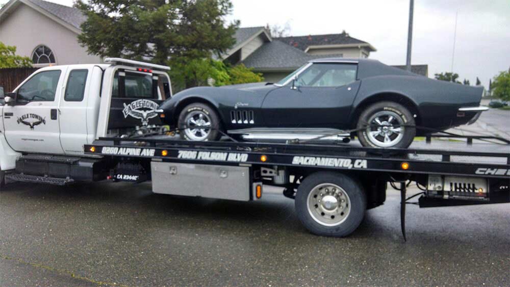 Eagle Tow Truck with Black Car on the back — Lockouts in Sacramento, CA