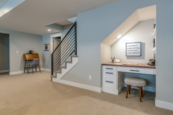 There is a desk under the stairs in the basement.