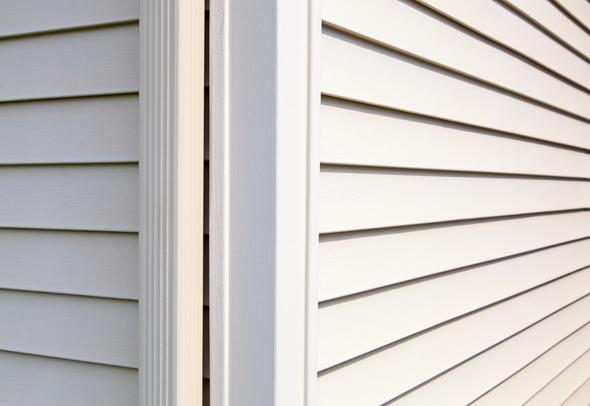 A close up of a white siding on a house