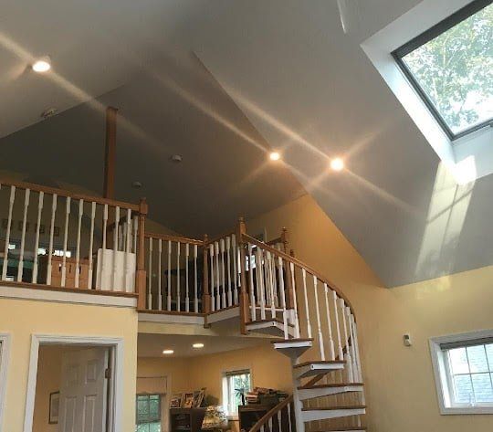 A house with a spiral staircase and a skylight
