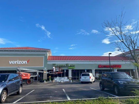 A verizon store is being painted in a parking lot.