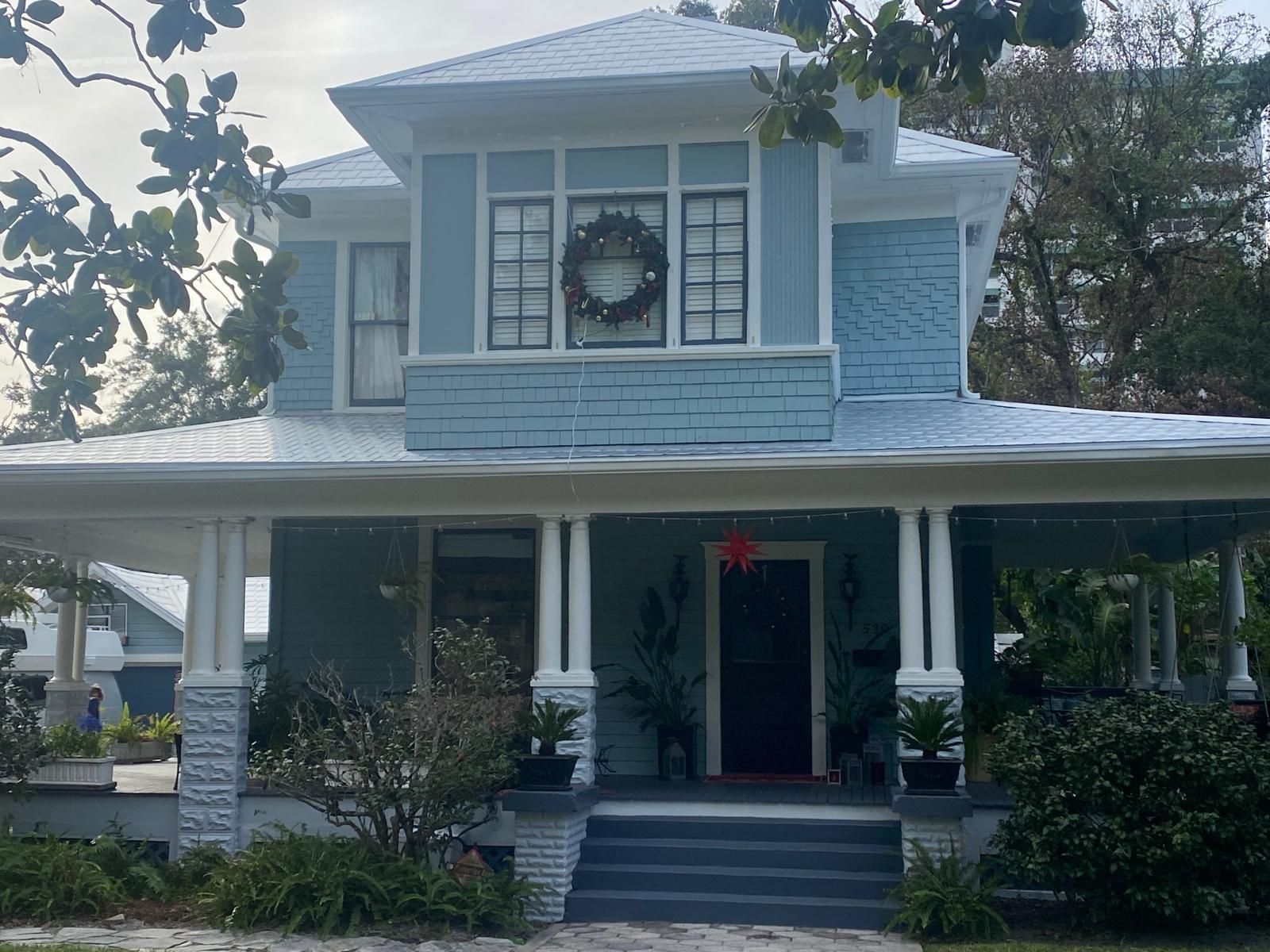 A blue house with a wreath on the front door