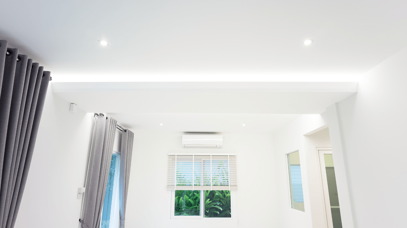 Bright white interior with a window, curtains, and recessed lighting — Intolec Electrical In Tweed Heads, NSW