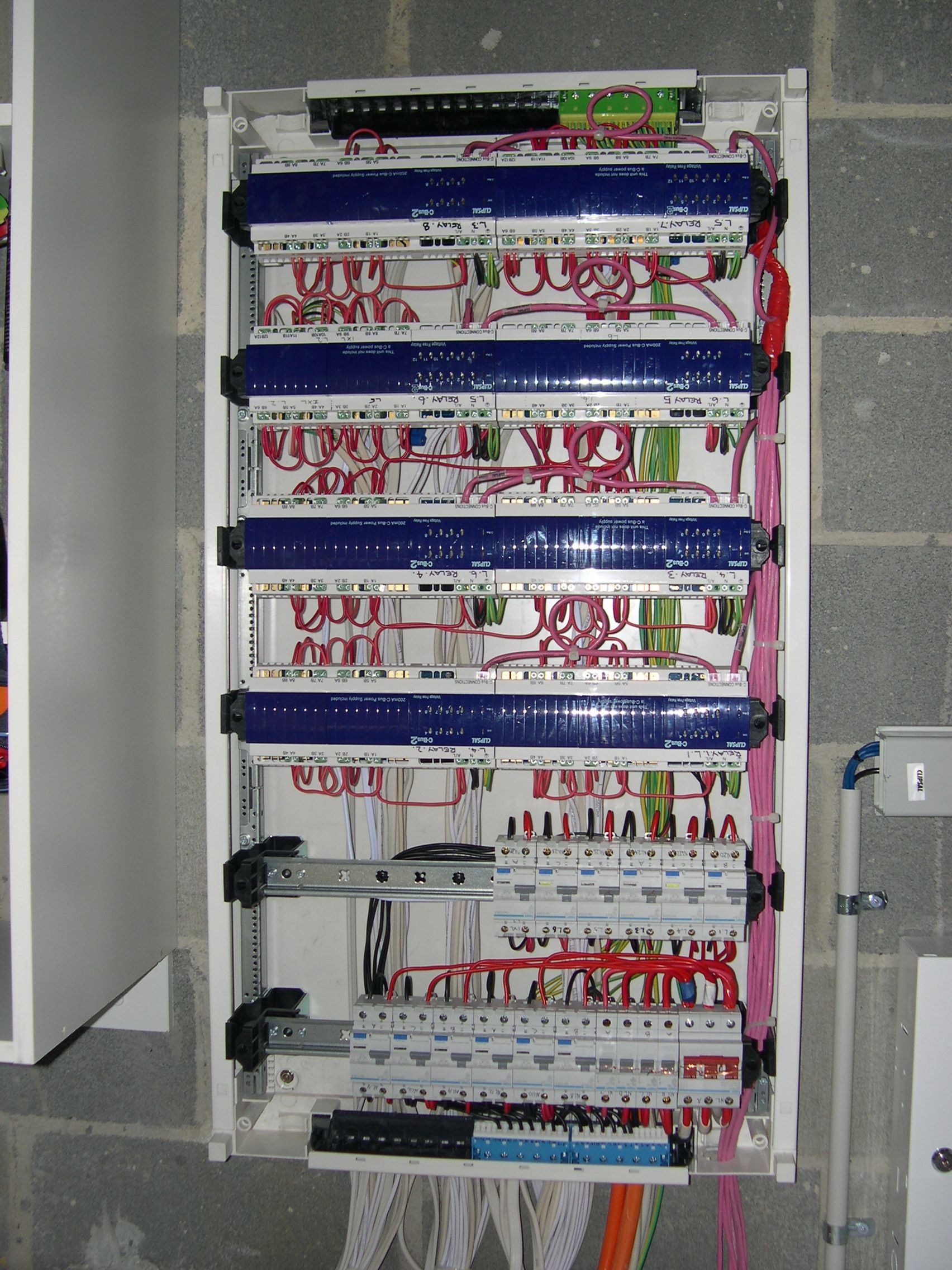 Electrical Panel With Rows of Circuit Breakers and Wires — Intolec Electrical in Tweed Heads, NSW