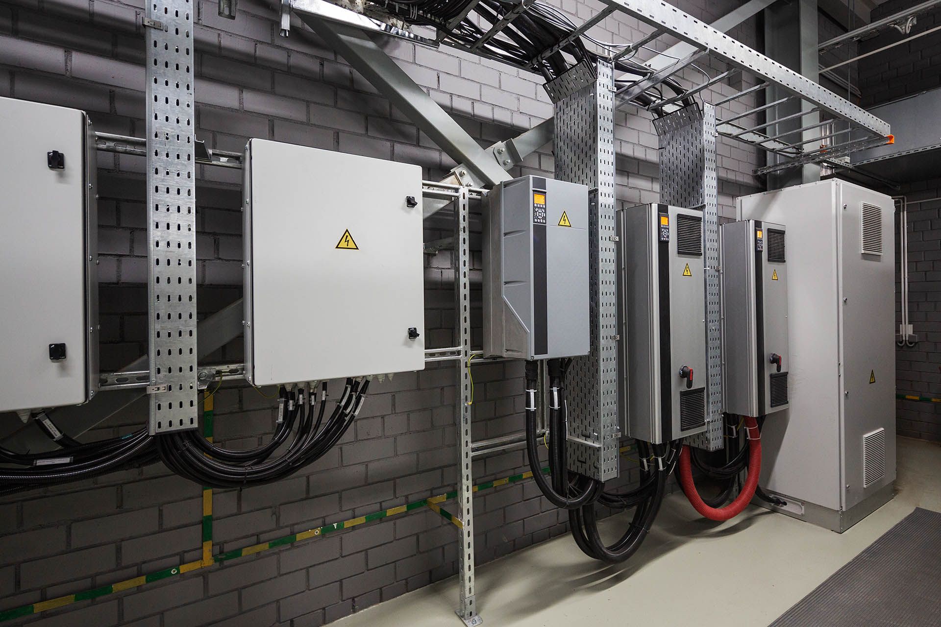 Large, Empty Warehouse With Concrete Floor, Tall White Pillars, and Metal Roof — Intolec Electrical In Tweed Heads, NSW