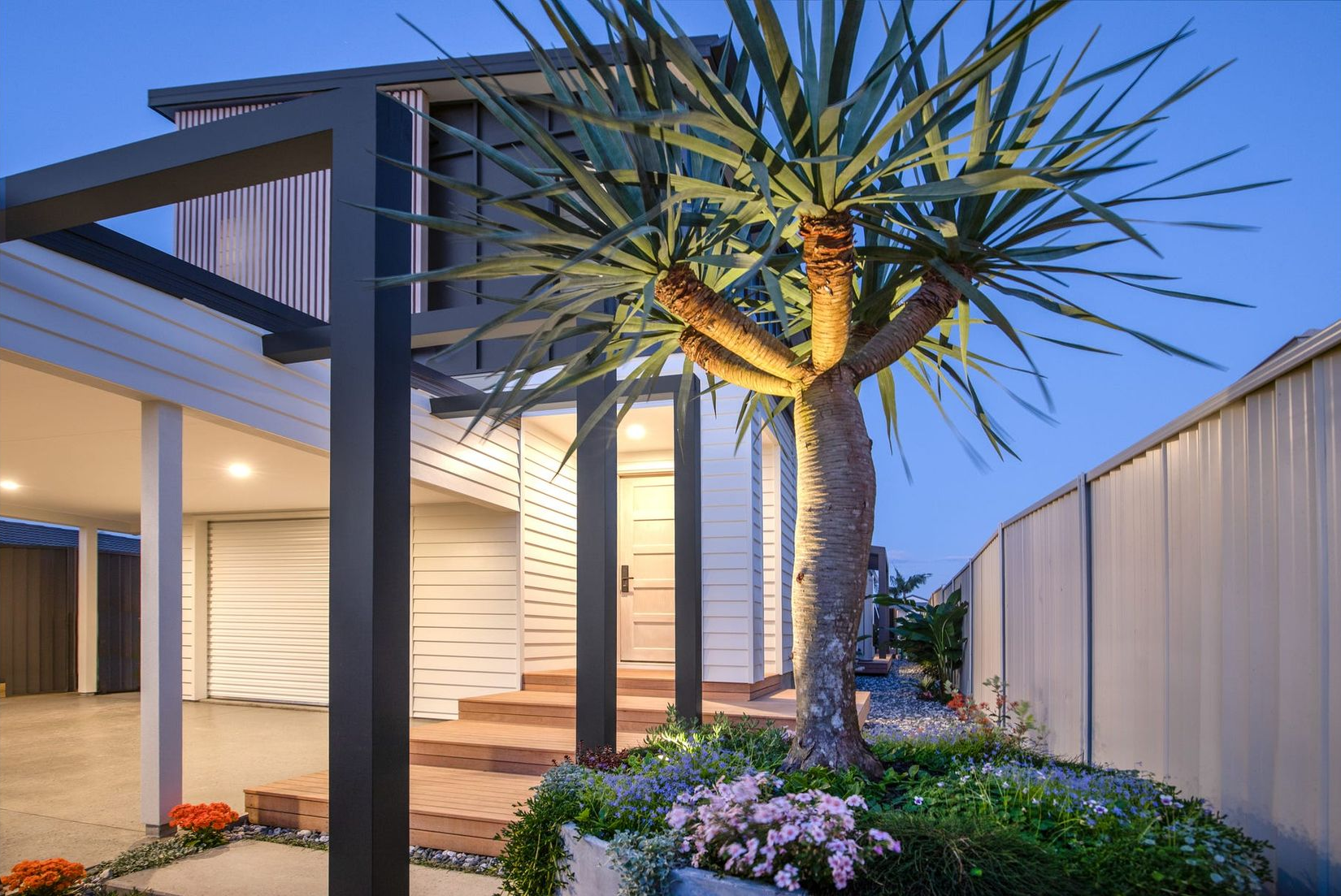 White and Gold Pendant Light Hanging in Front of a Brick Wall With a Plant — Intolec Electrical In Tweed Heads, NSW