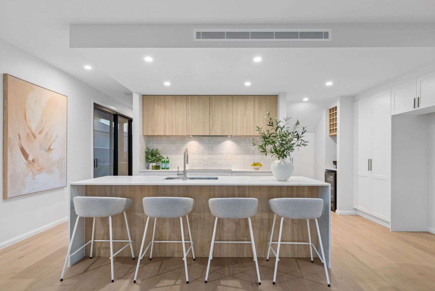 Wooden shelves with plants, woven lamps hang above. Cafe setting with a corrugated metal base. — Intolec Electrical In Tweed Heads, NSW
