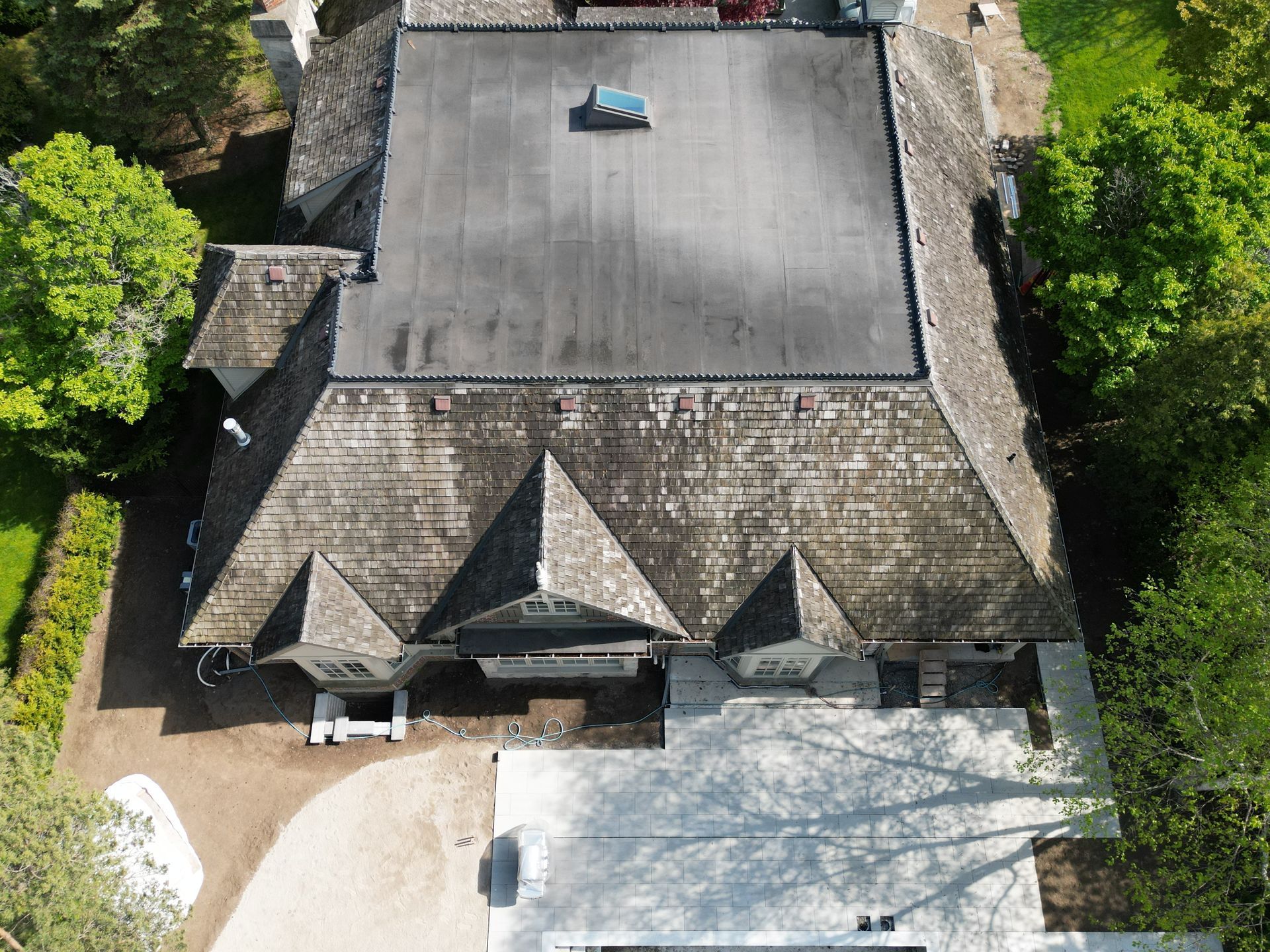 An aerial view of a house with a black roof