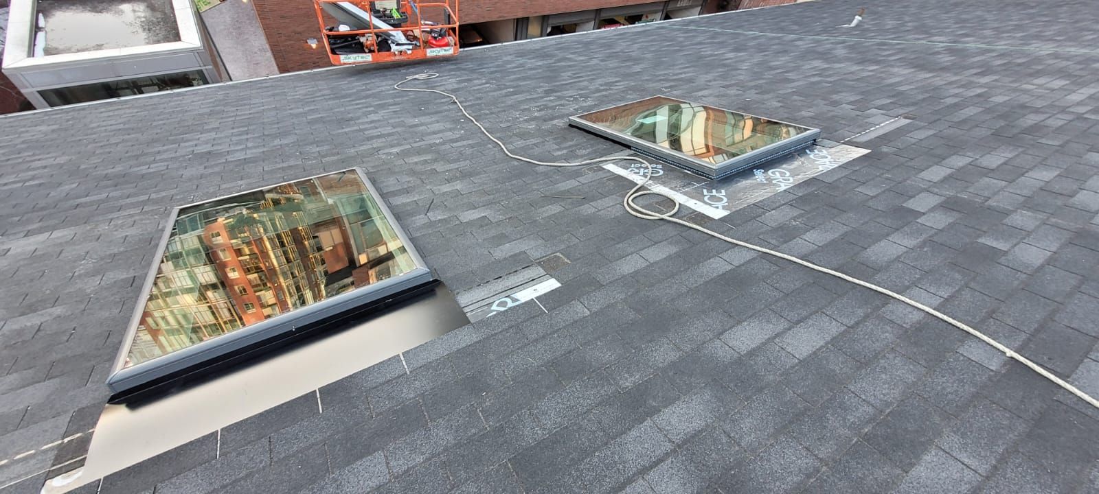 There are two skylights on the roof of a building.