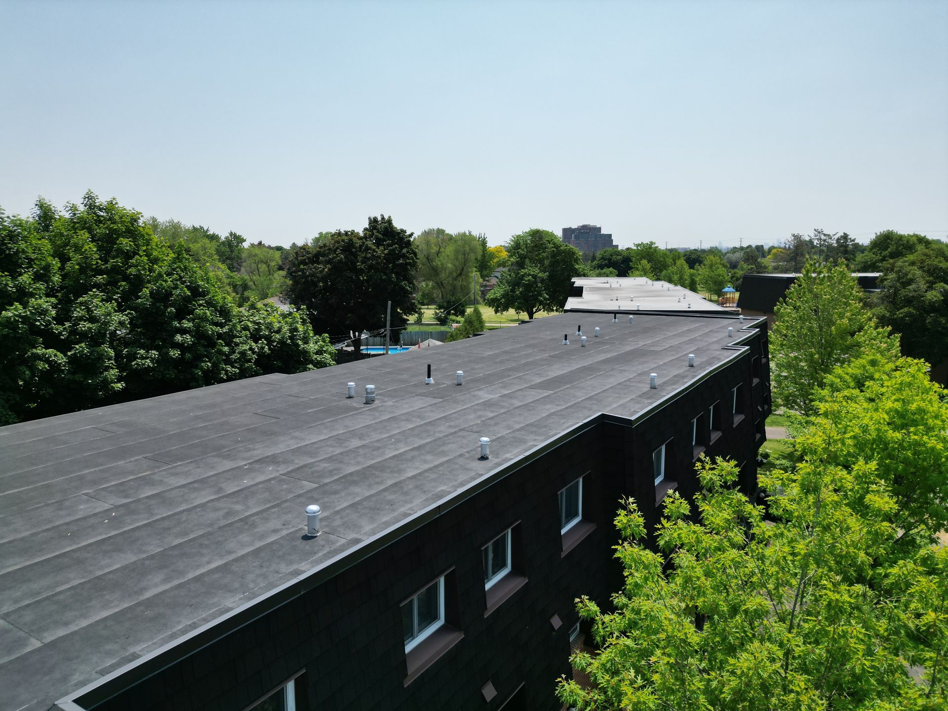 An aerial view of a building with a black roof