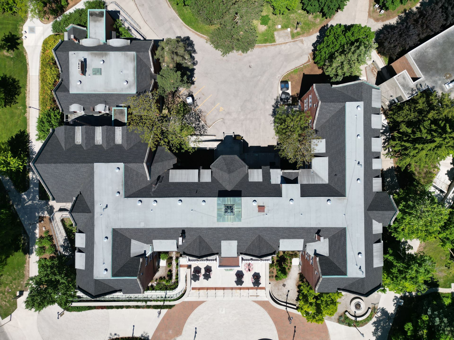 An aerial view of a large building surrounded by trees