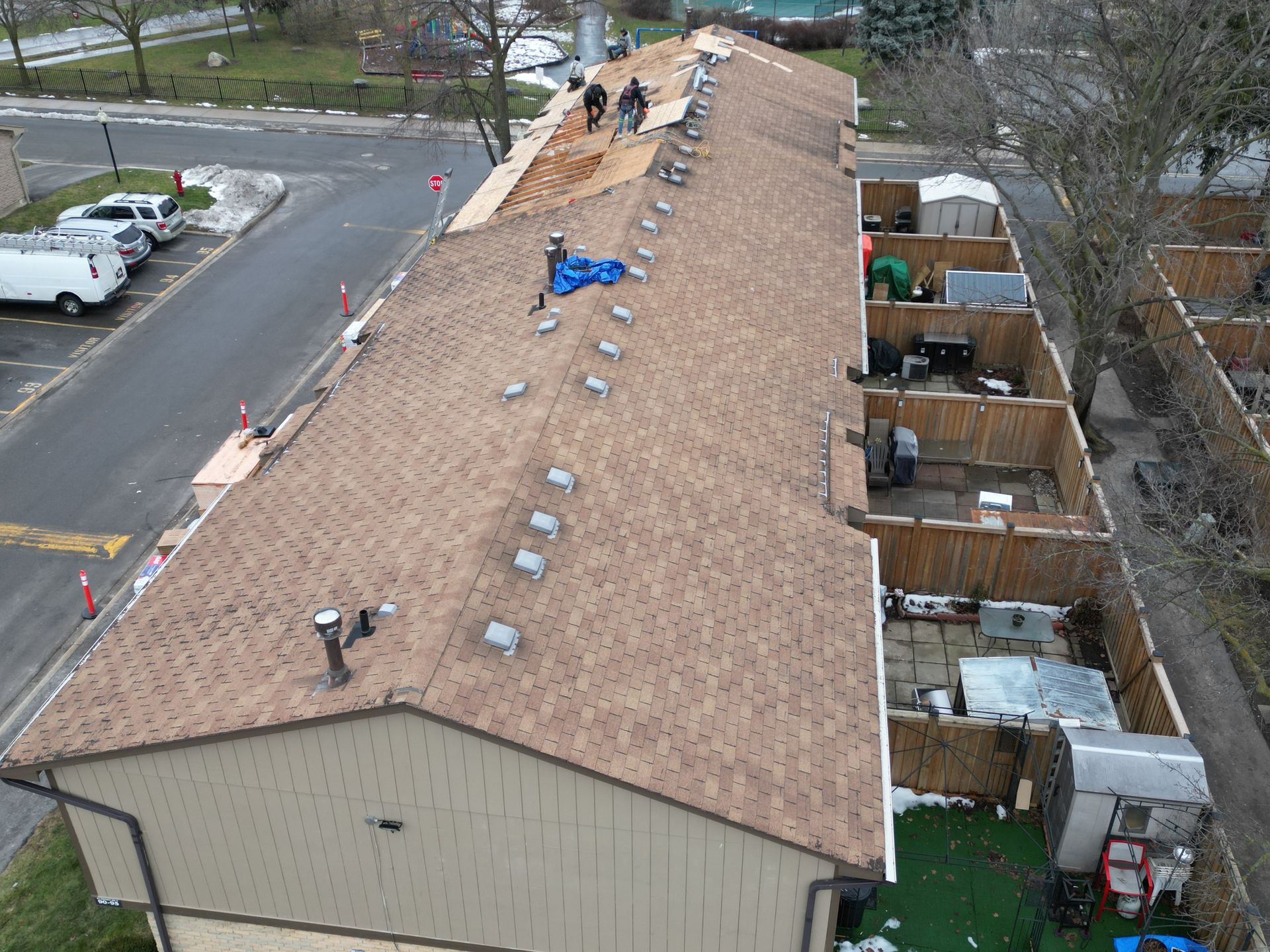 A group of people are working on the roof of a building