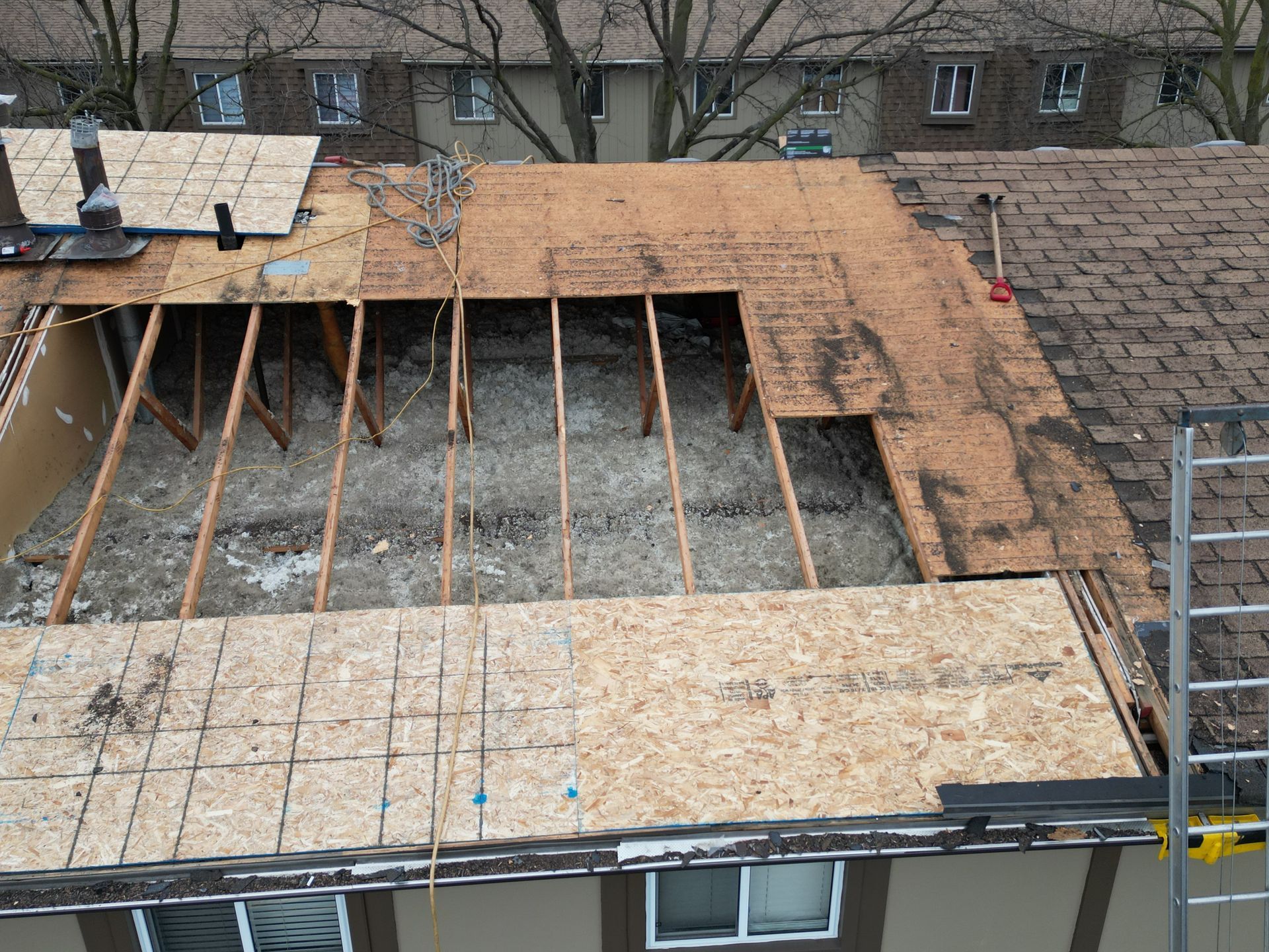 An aerial view of a roof that is being remodeled
